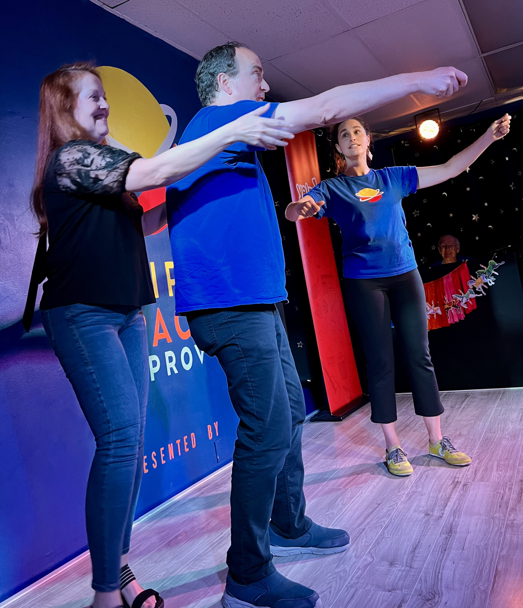 An audience volunteer on stage at Third Space Improv